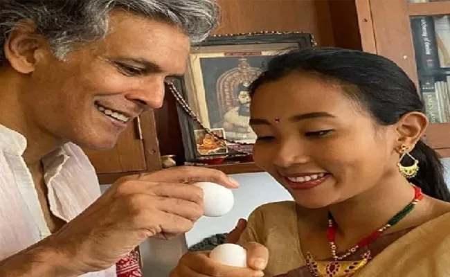 Milind Soman Egg Fight With Ankita Konwar For Celebrates Rongali Bihu - Sakshi