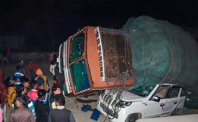 Truck Overturns On Road In Madhya Pradesh - Sakshi