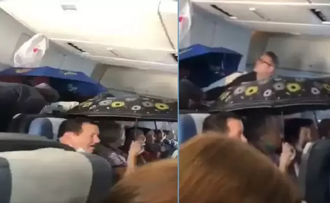 Passengers On Russian Flight Hold Up Umbrellas Video Goes Viral  - Sakshi