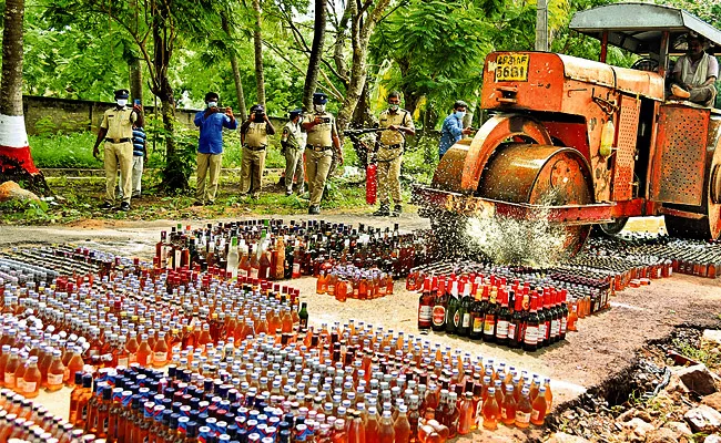 14 Thousnad Seized Liquor Bottles Destroyed in Machilipatnam - Sakshi