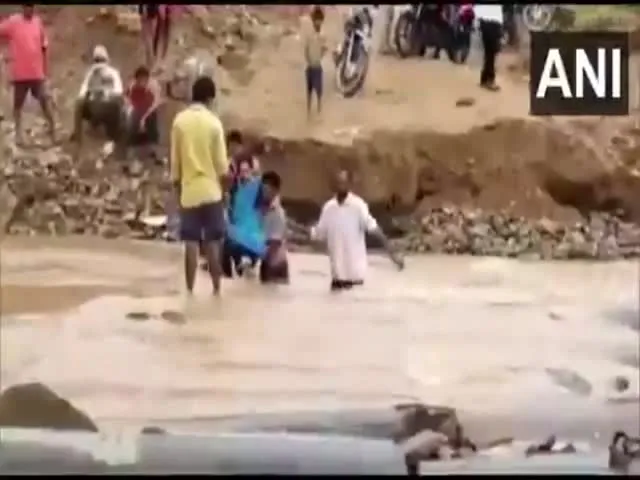 Pregnant Woman Crossing Water Stream In Kothagudem