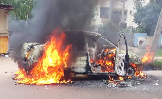 Car Burned On The Road Near Pendurthi - Sakshi