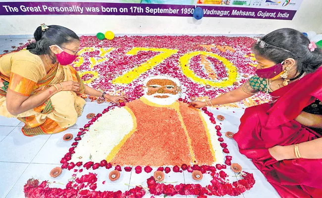 BJP workers celebrate PM Narendra Modi 70th birthday - Sakshi