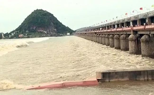 Heavy Flood Water Reaches Prakasam Barrage - Sakshi