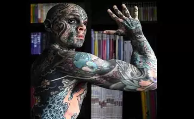 Teacher Covers Entire Body With Tattoos And Turns His Eyes Black - Sakshi