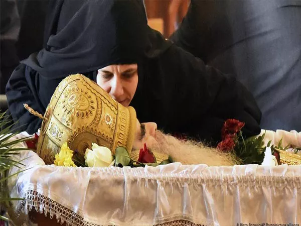 Mourners kiss Coronavirus Infected bishop at Montenegro At His Funeral - Sakshi