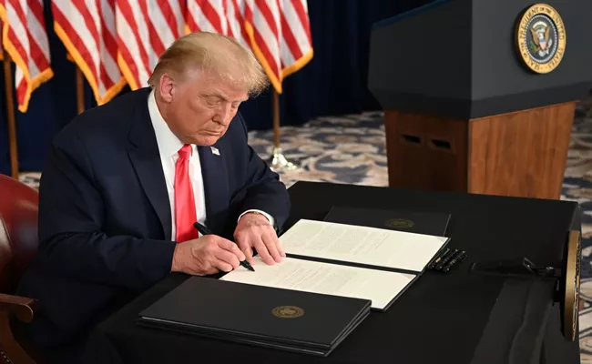 US President Donald Trump signed the COVID Relief Bill - Sakshi