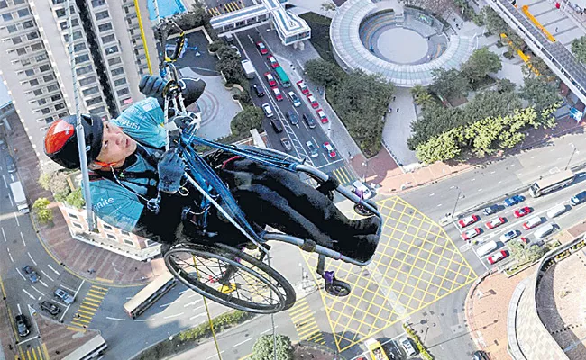 Hong Kong: On Wheelchair Paraplegic Lai Chi wai Climbs Up Skyscraper - Sakshi