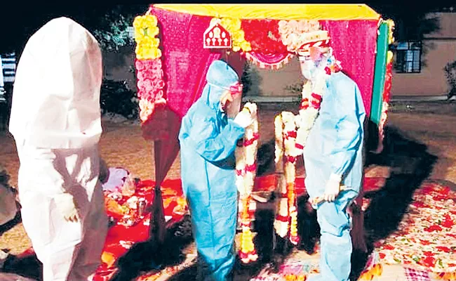 Rajasthan couple ties knot in PPE kits after bride tests Covid-19 positive - Sakshi