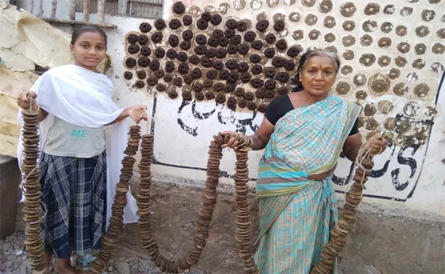 Bhogi Celebration With 1 Lakh Cow Dung Cakes In Srikakulam - Sakshi