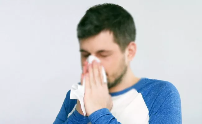 Man Holding His Nose And Covering His Mouth While Sneezing Hospitalized - Sakshi