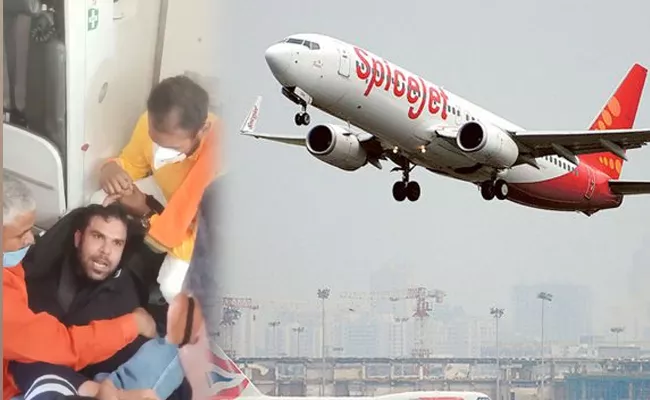 SpiceJet Flight  Passenger Tries to Open Emergency Door Mid-air - Sakshi