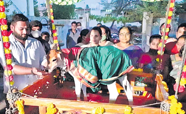  a baby calf  cradle ceremony celebrated by her owner - Sakshi