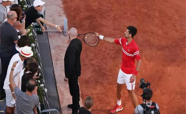 French Open 2021: Djokovic Gifts Winning Racquet to Young Fan - Sakshi