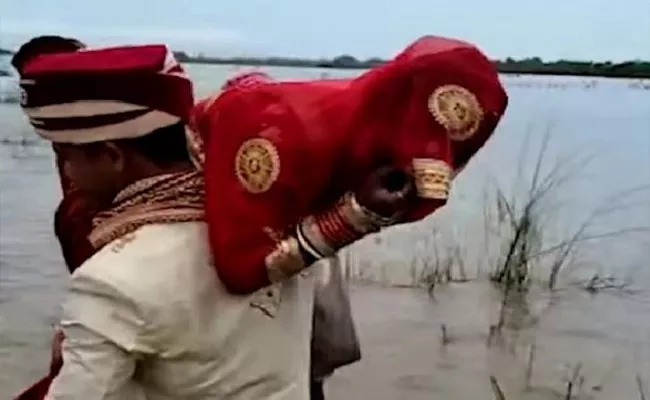 Groom Lifts Up Bride On Shoulder Cross River After Boat Stuck In Sand - Sakshi