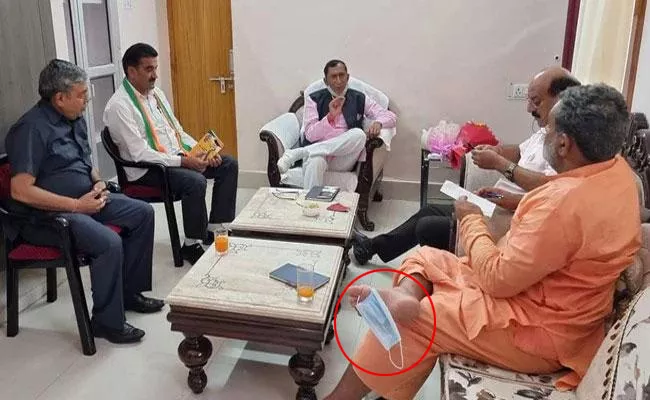 Uttarakhand Minister Seen With Mask Hanging Off Toe - Sakshi