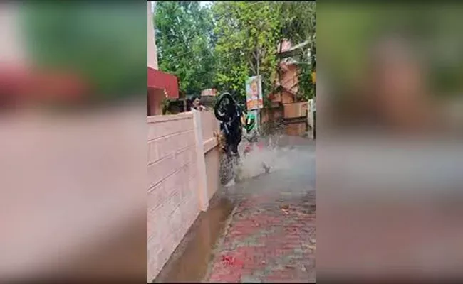 Viral Video: Bike Stunt Goes Horribly Wrong Man Breaks Neighbours Wall - Sakshi