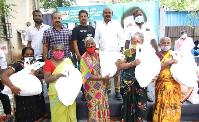 Film Producer Ravindran Distributed Groceries To Poor Families - Sakshi