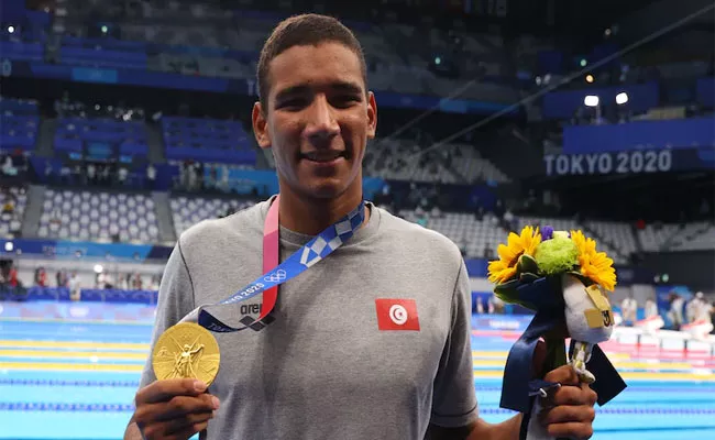 Tunisia Swimmer Ahmed Hafnaoui Wins Gold In Mens 400 Freestyle - Sakshi