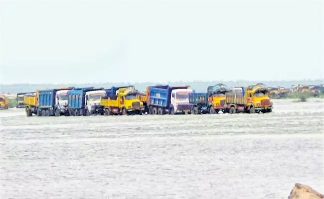 Drivers Of 123 Lorry Tippers Stranded In The Middle Of The River - Sakshi