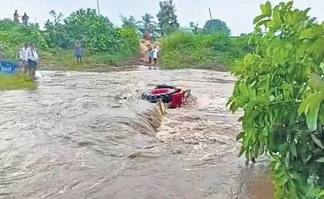 Telangana: Tractor Stuck In Overflowing Stream In Srikonda - Sakshi