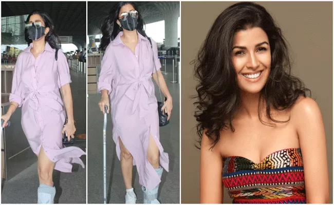 Actress Nimrat Kaur Spotted At Airport With Injured Leg - Sakshi