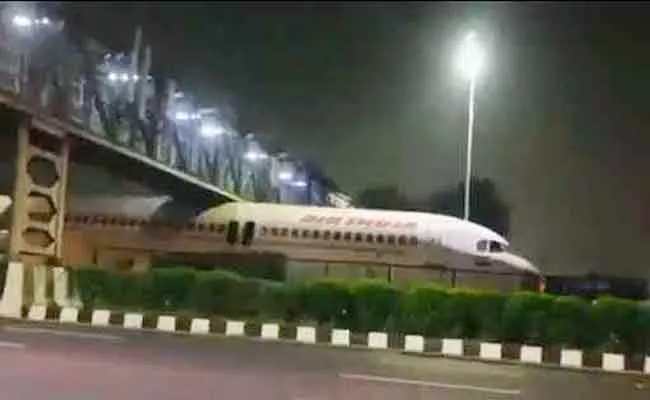 Air India Scrap Plane Stuck Under Foot Over Bridge In Delhi Viral Video - Sakshi