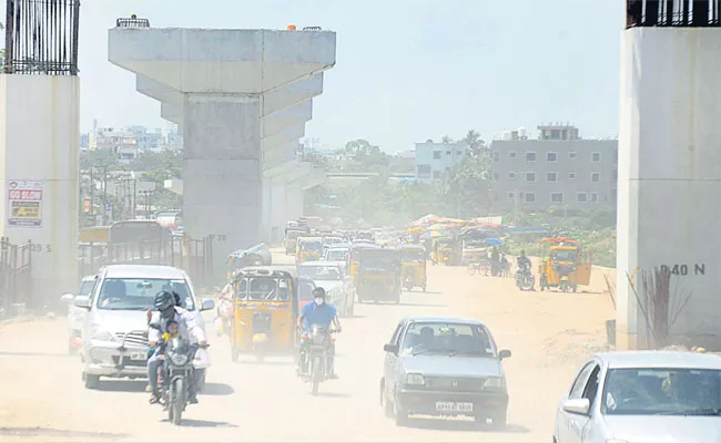 Heavy Dust, Traffic Jams in Hyderabad Due To Delay Of Uppal Flyover - Sakshi