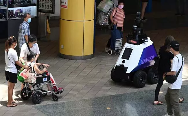 Singpore Government Says Robots Now Patrol Streets To Deter Undesirable Social Behaviour - Sakshi