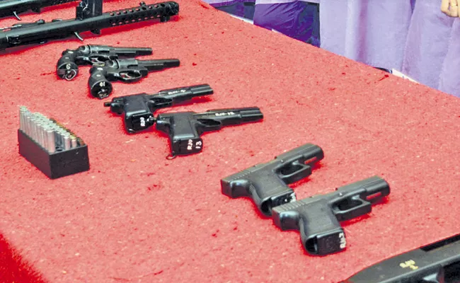 Some police officers Shared Guns in East Godavari district - Sakshi