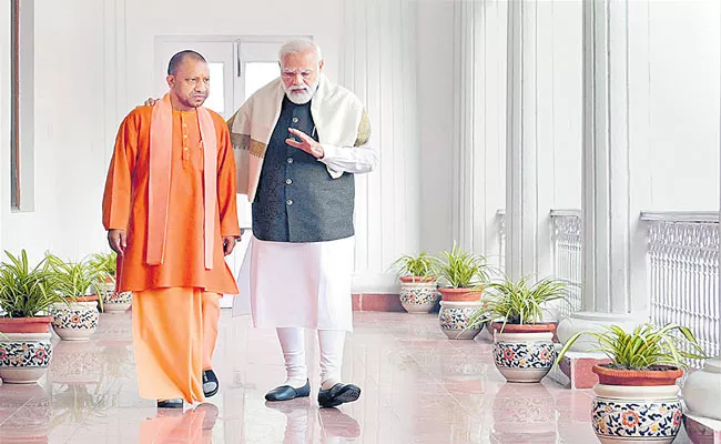 UP CM Yogi Adityanath shares picture with PM Modi, says committed to building new India - Sakshi