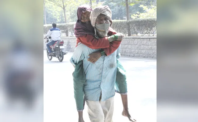 Responsibility: Son Carries His Mother On His Back In Nizamabad - Sakshi