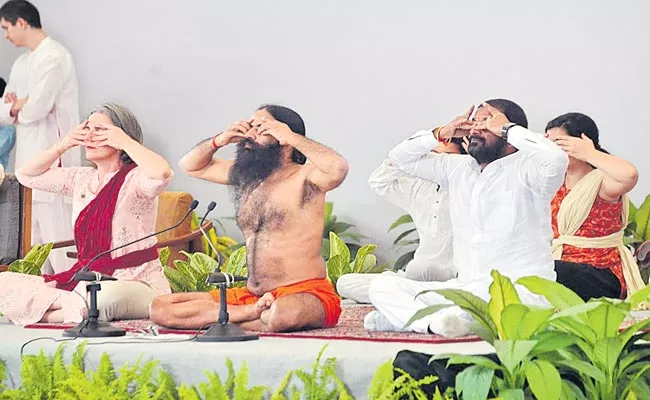 Sarbananda Sonowal Launches 75 Crore Surya Namaskar Initiative By Ramdev - Sakshi