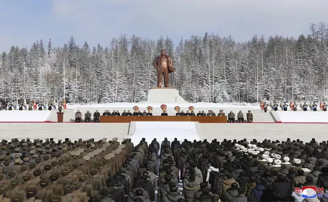 In freezing Cold Thousands People Stood Kims Father Statue - Sakshi