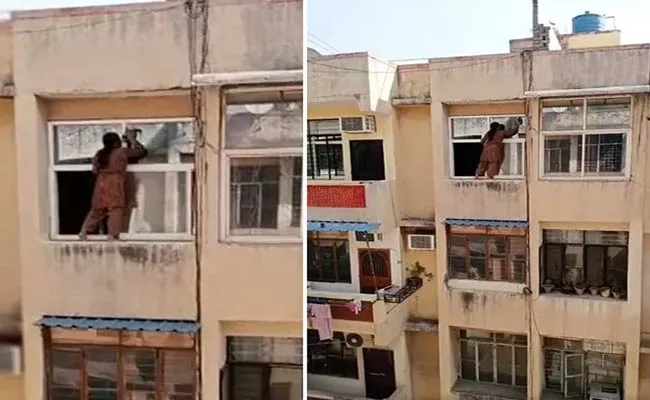 Ghaziabad Woman Stands On 4th-floor Railing To Clean Window - Sakshi