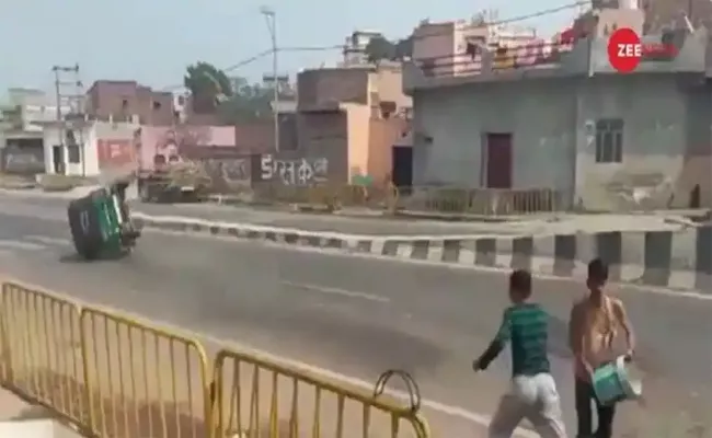  Holi Reveler Throwing Water Balloon Toppling Auto On The Ground - Sakshi