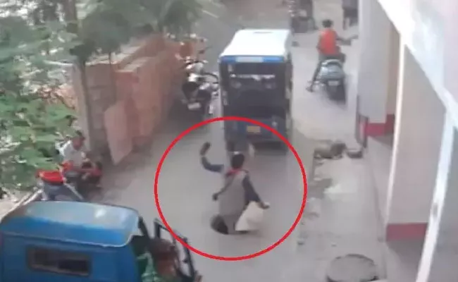 Woman Falls Into Open Manhole While Talking On Phone - Sakshi