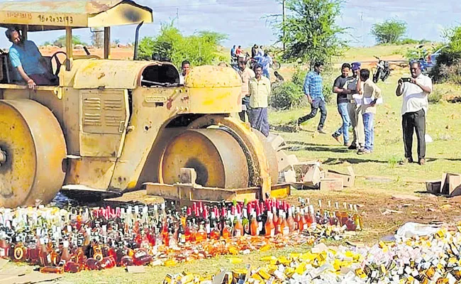 Seized Liquor Bottles Crushed Under Road Roller In Rayachoti - Sakshi