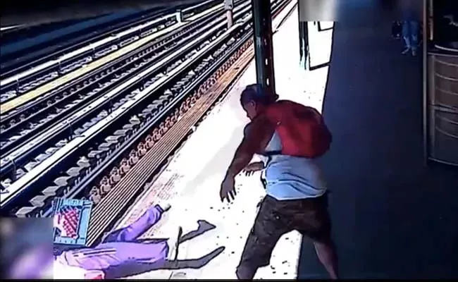 Man Pushing Woman Onto Railway Tracks At NewYork Viral - Sakshi