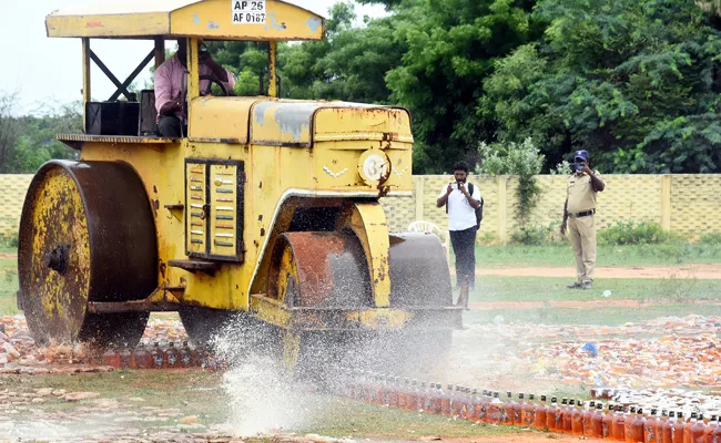 Liquor Bottles Worth Rs 13 Crores Crushed Under Road Roller At Nellore - Sakshi