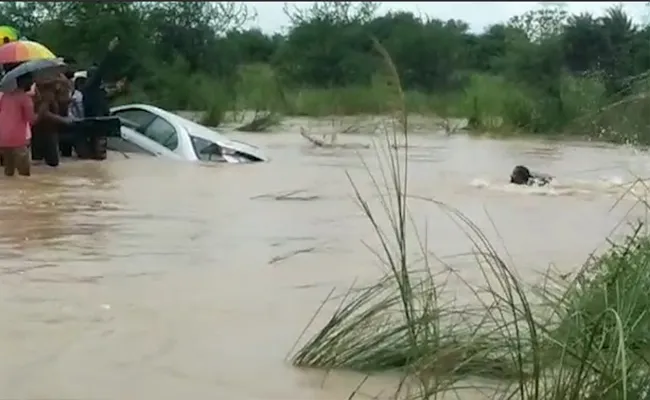 Telangana Rains: Car Washed Away in Floods At Warangal - Sakshi