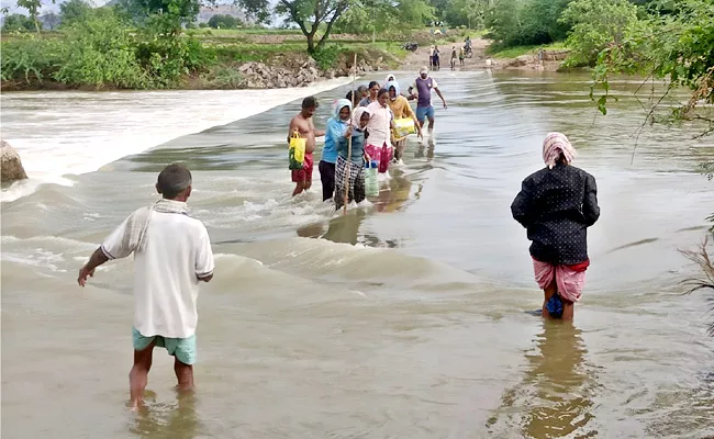 Telangana Floods: Women Labourers Stuck In Low Level Bridge - Sakshi