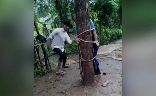 Woman Tied To Tree Thrashed After Husband Sees Her With Friend - Sakshi