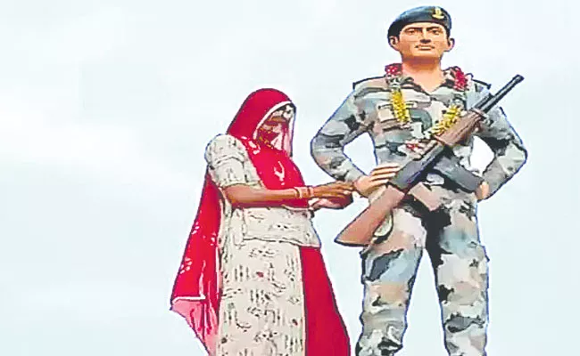 Woman Ties Rakhi On Brother's Statue In Rajasthan - Sakshi