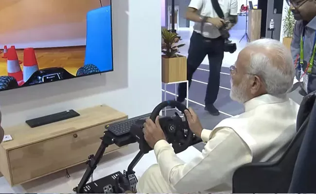 PM Modi Tests Driving A Car In Europe Remotely From Delhi - Sakshi