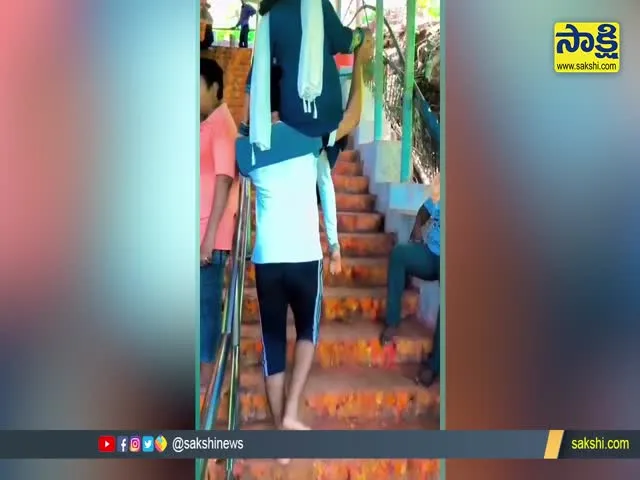 Viral Video : Husband Carries Wife On Shoulder In Tirumala Steps