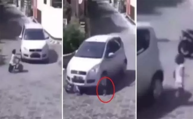 Viral Video: The Wheel Of The Car Passes Over The Child But Alive - Sakshi