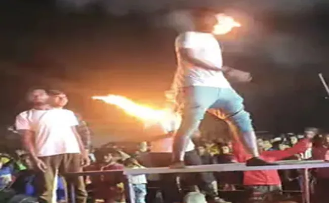 A Man Attempts A Risky Fire Stunt Beard Catches Fire Video Viral - Sakshi