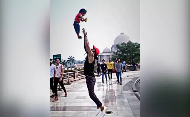 Father Perform Stunt Throwing His Little Son High Up In The Air  - Sakshi