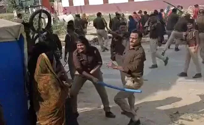 UP Police Raining Lathis On Women And Shouting Abuses  - Sakshi